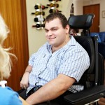 NDIS client, Zane McKenzie talking with his disability care worker