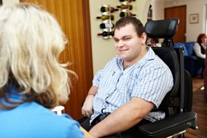 NDIS client, Zane McKenzie talking with his disability care worker
