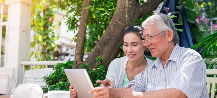 Daughter helping father with laptop