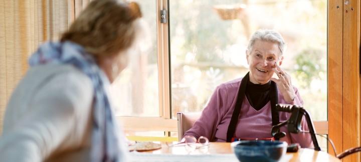 Elderly woman talking with carer