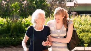 Mother and daughter walking arm-in-arm