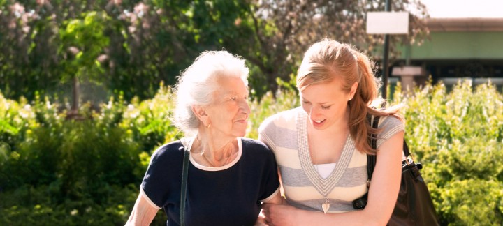 Mother and daughter walking arm-in-arm