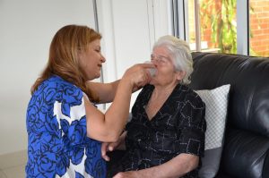 Woman assisting elderly mother