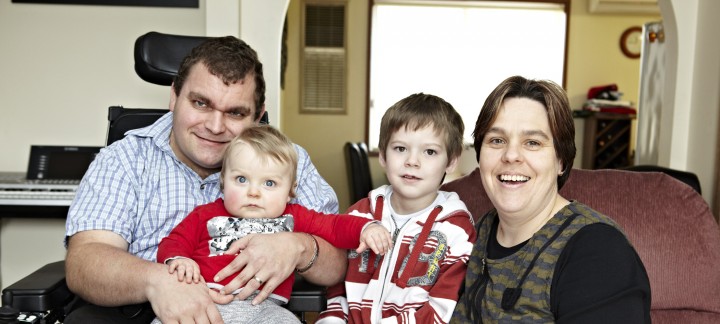 NDIS client, Zane McKenzie with his wife, young son, and baby son